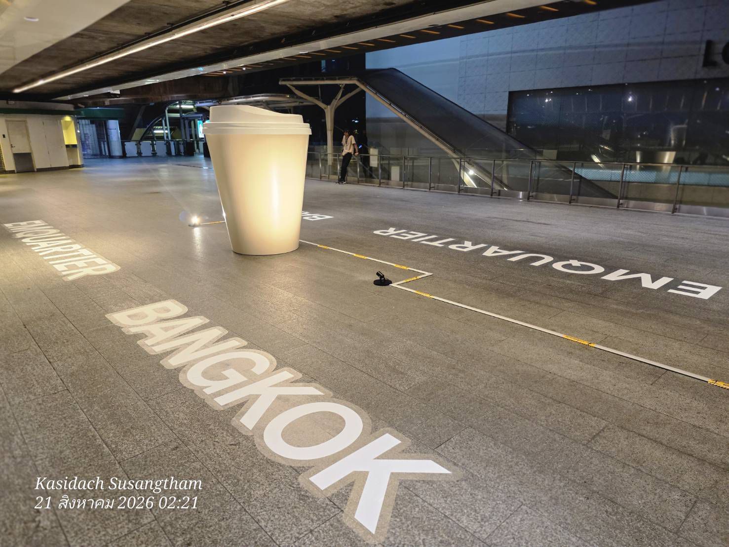 The giant cup beside the BANGKOK floor graphic