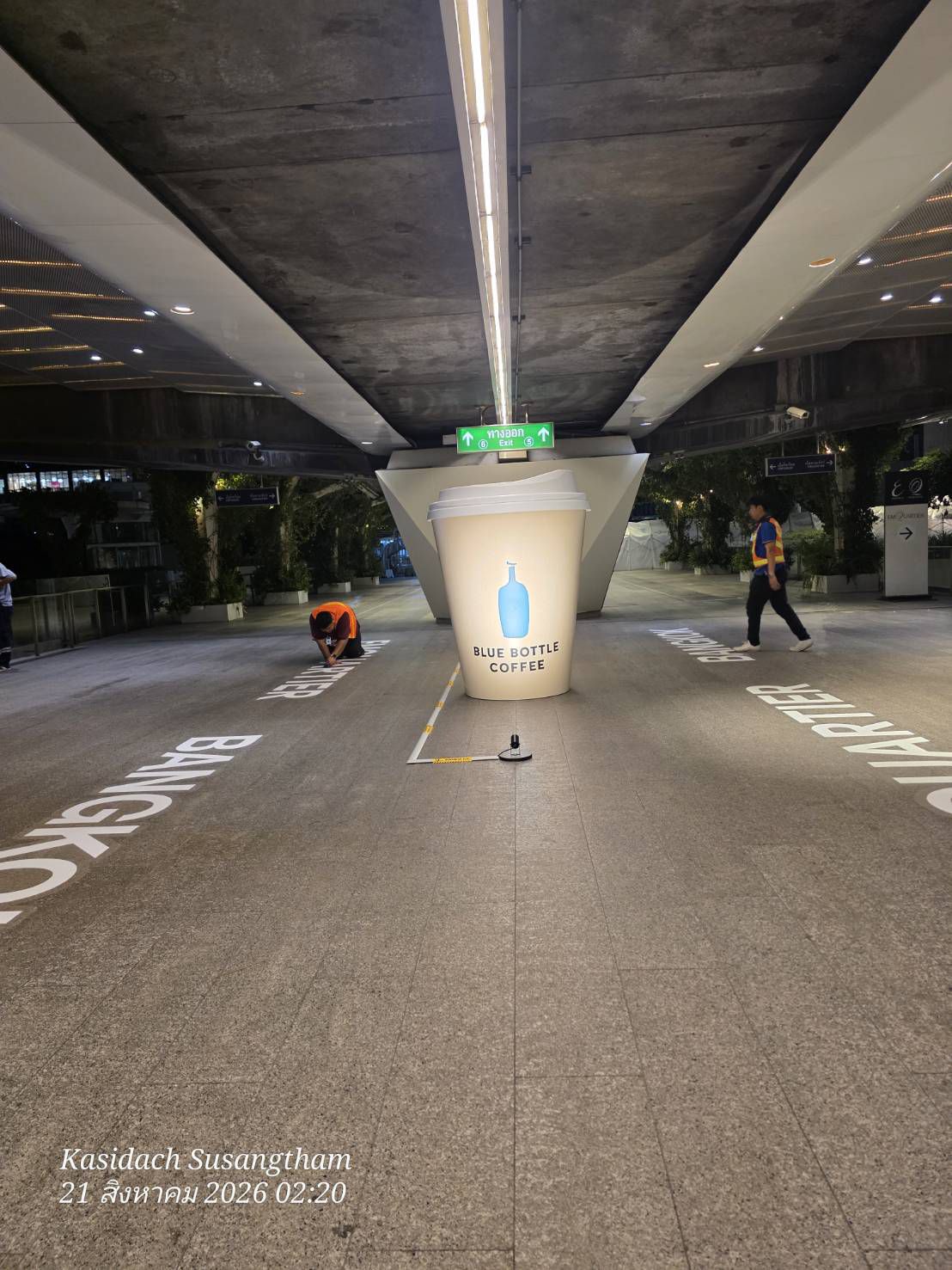 The illuminated cup along the covered walkway