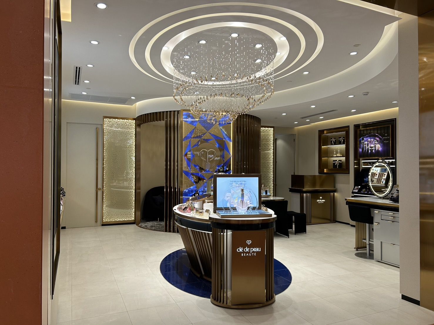 Clé de Peau Beauté at Central Chidlom — chandelier ring over the island counter