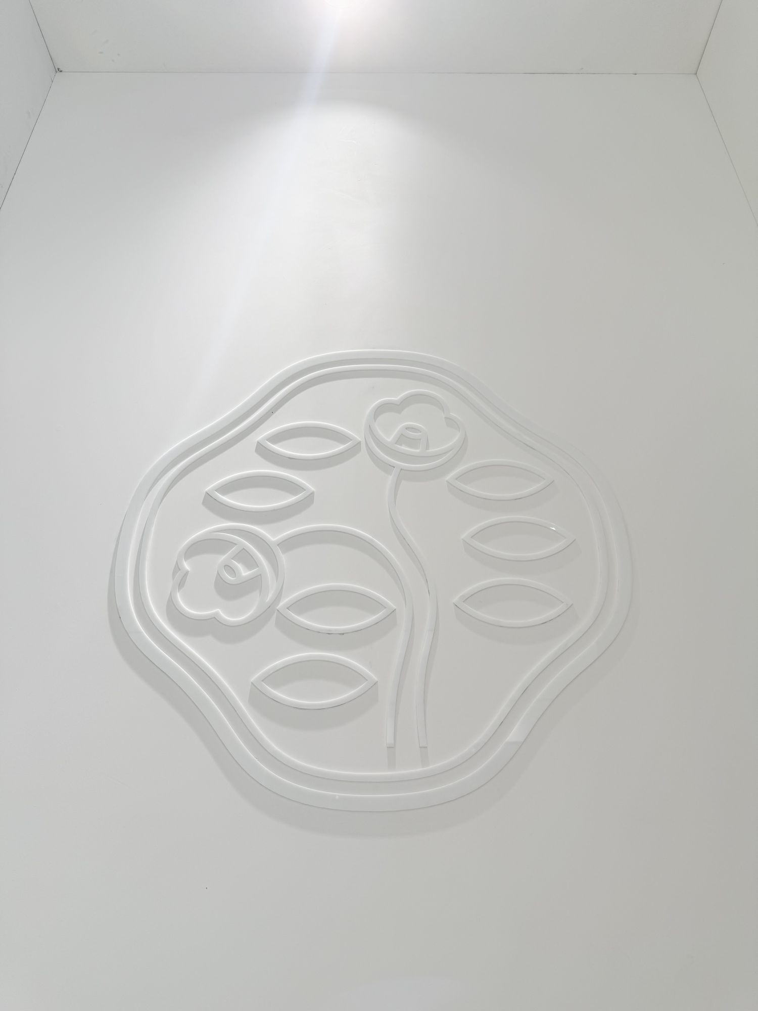 Shiseido camellia emblem in relief